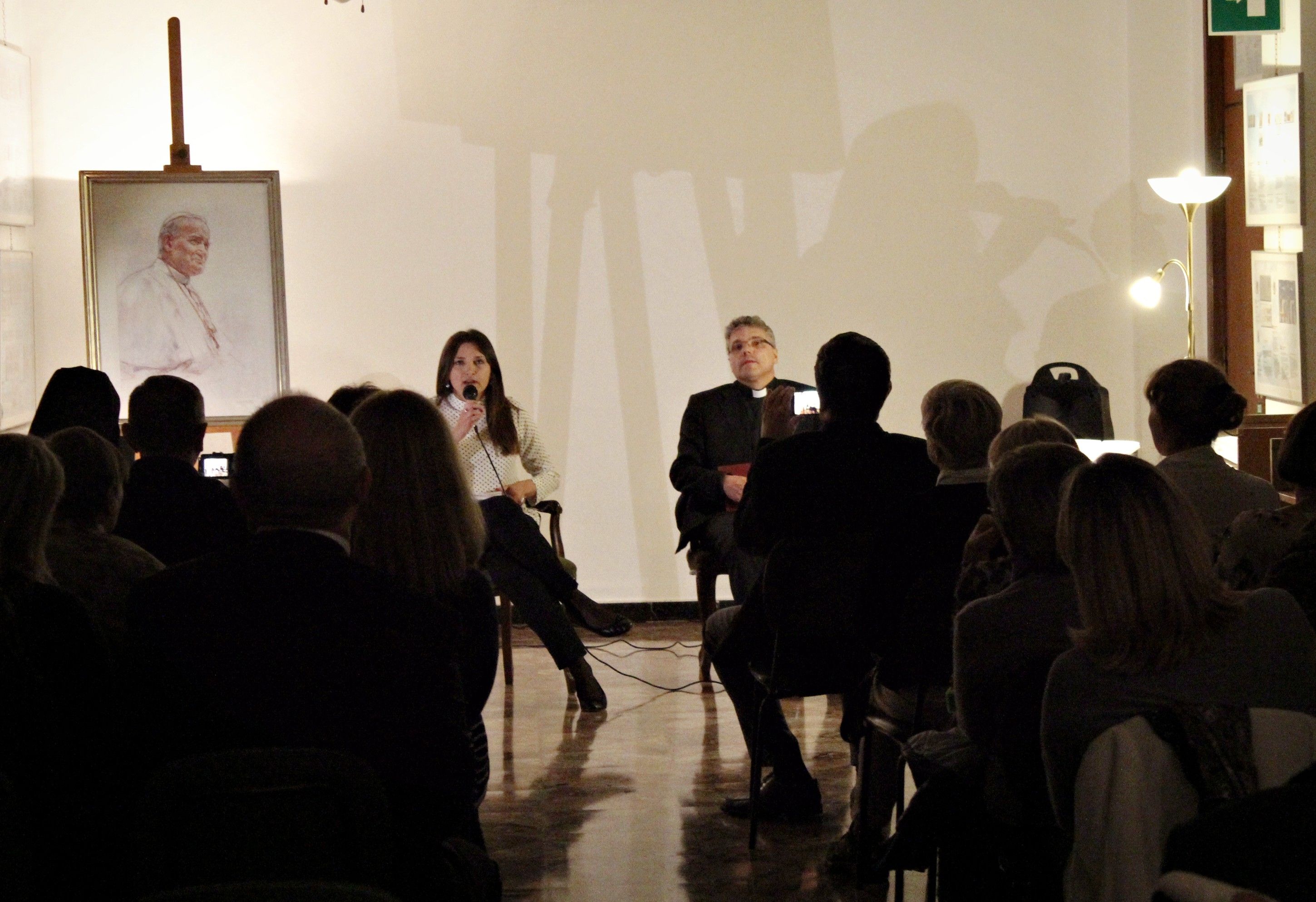 Event with audience, portrait of St. John Paul II in the background